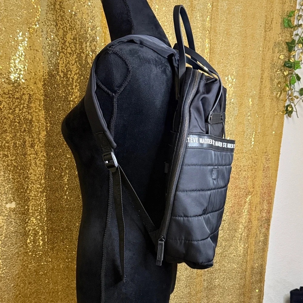 Steve Madden Bjodah Black Quilted Backpack with carry handles and branded strap